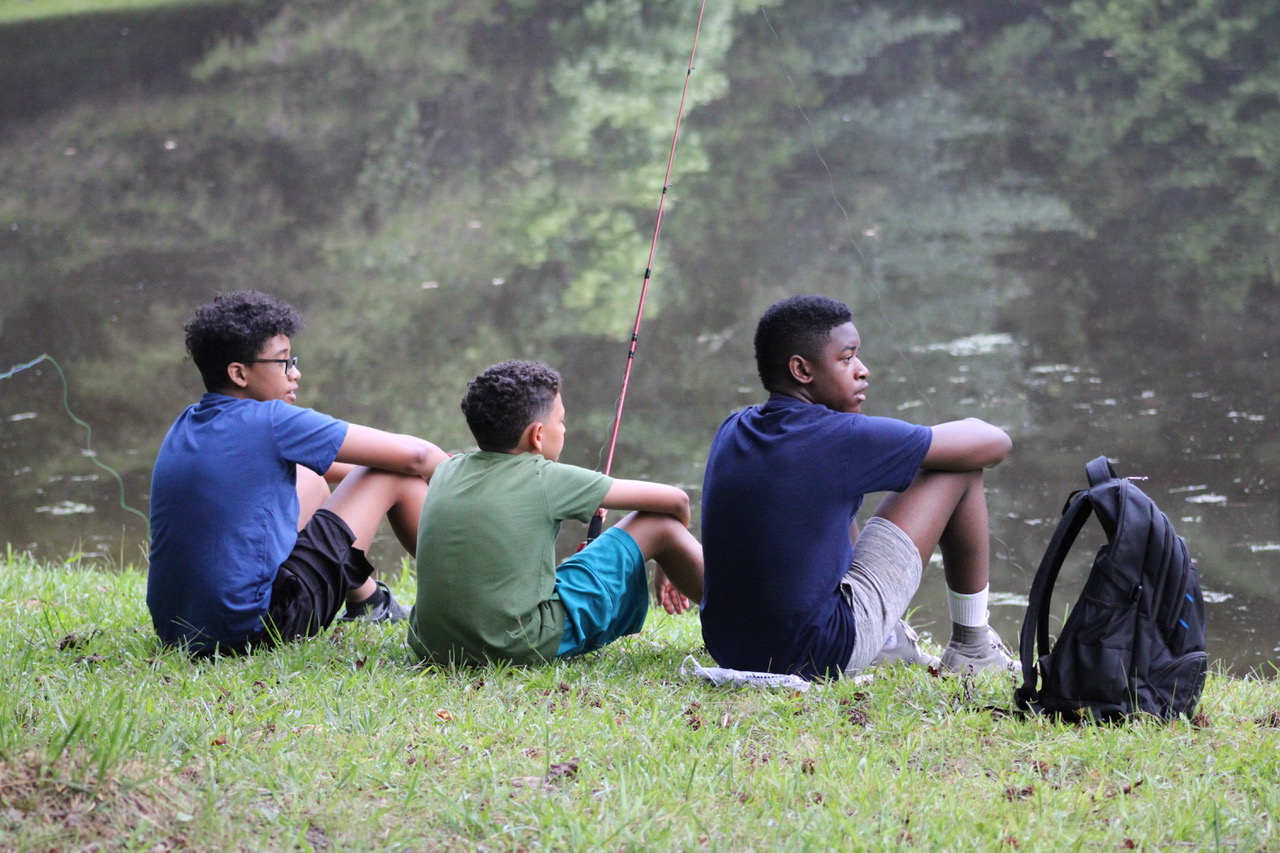 Campers fishing by the lake